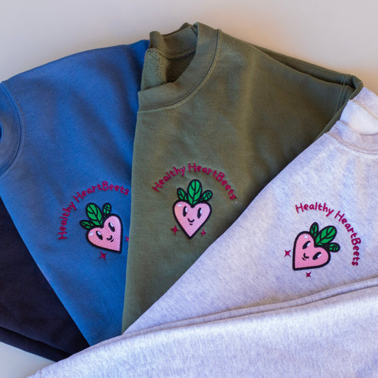 Folded sweatshirts with 'Healthy Hearts' design on a light background